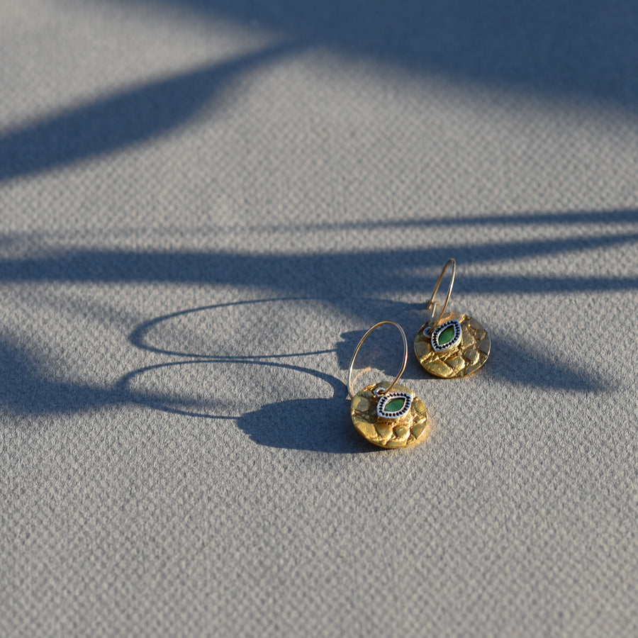 Gold disc crocodile texture earring with silver and emerald third eye. Handmade in Mexico City. 